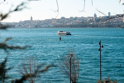 A captivating view of the Bosphorus strait with the Istanbul skyline in the background, showcasing a ferry on a sunny day.