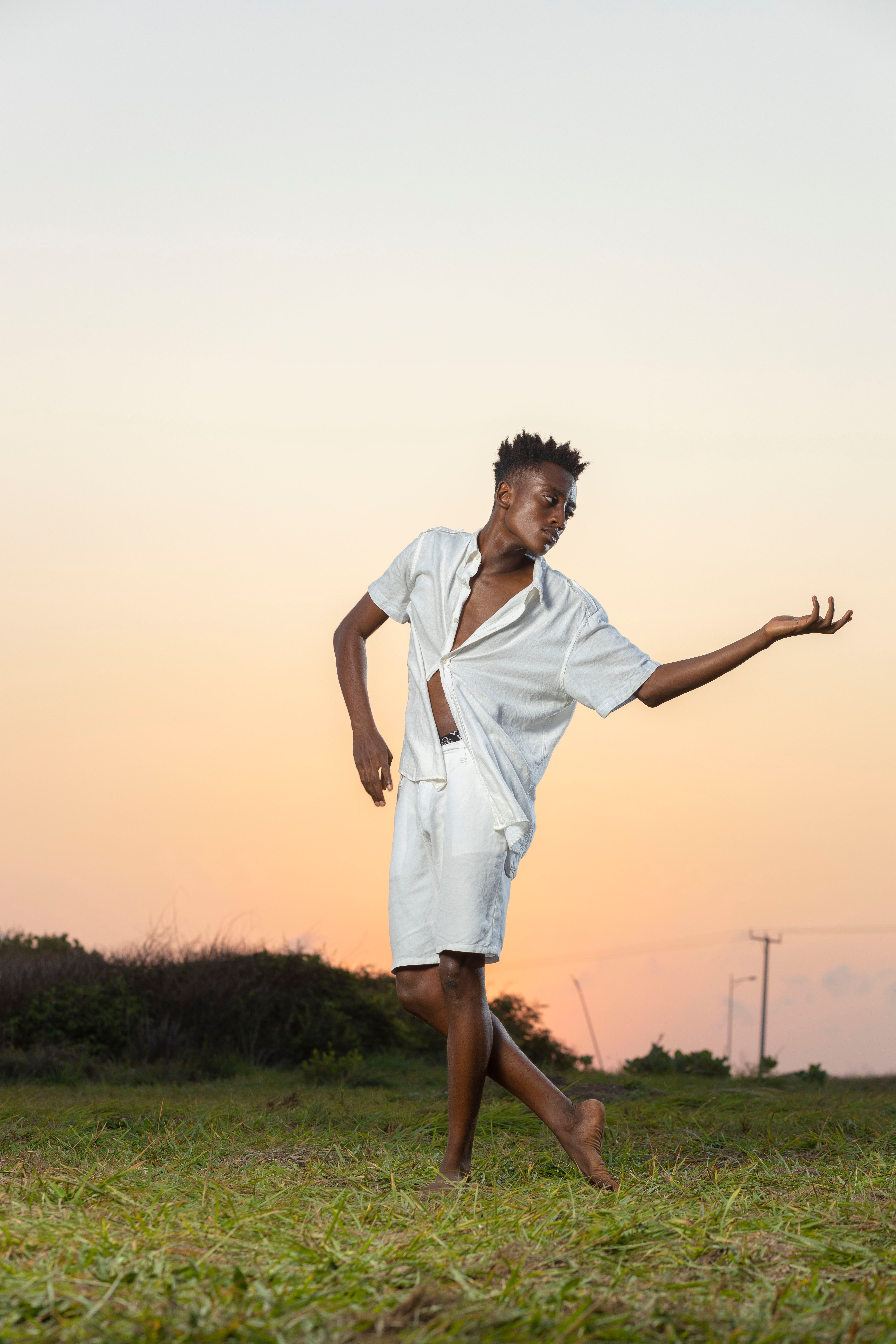 A dancer in motion during a vibrant sunset in Accra, Ghana.