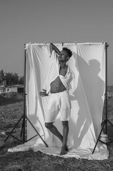Black and white portrait of a stylish man posing in Accra, Ghana.