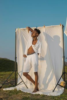 Artistic outdoor fashion portrait with a vibrant backdrop in Accra.