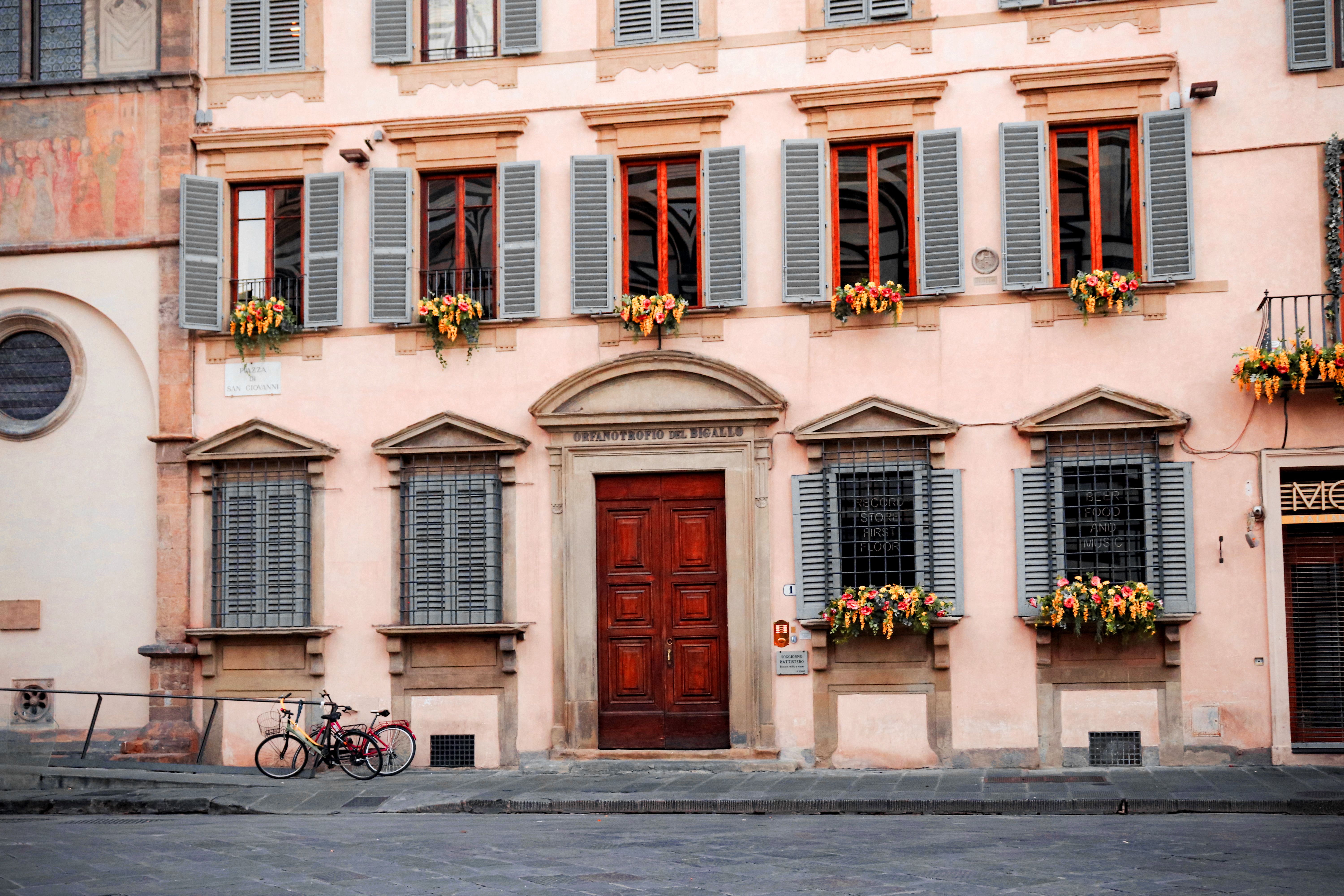 Charming Italian urban scene with architectural details and flower boxes.
