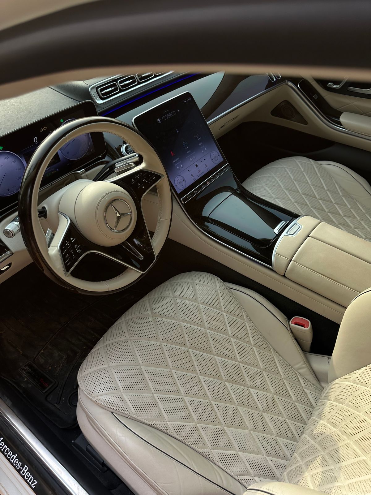 Premium car interior with modern dashboard, steering wheel, and leather seating