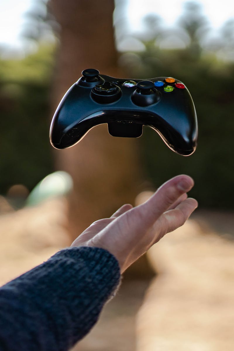 Photo of Person Catching Gamepad