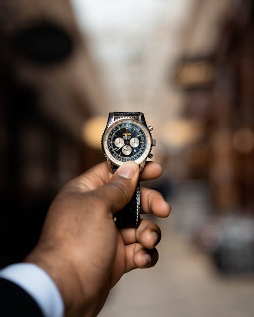 Free Person Holding Black and Silver Chronograph Watch Stock Photo