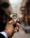 Person Holding Black and Silver Chronograph Watch