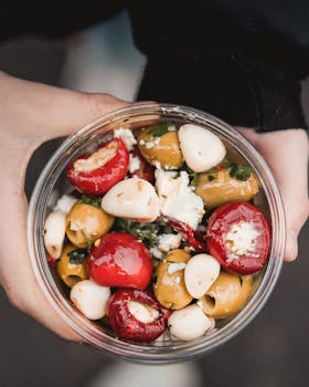 Enjoy a delicious Mediterranean salad bowl with olives, cheese, and peppers for a healthy meal.