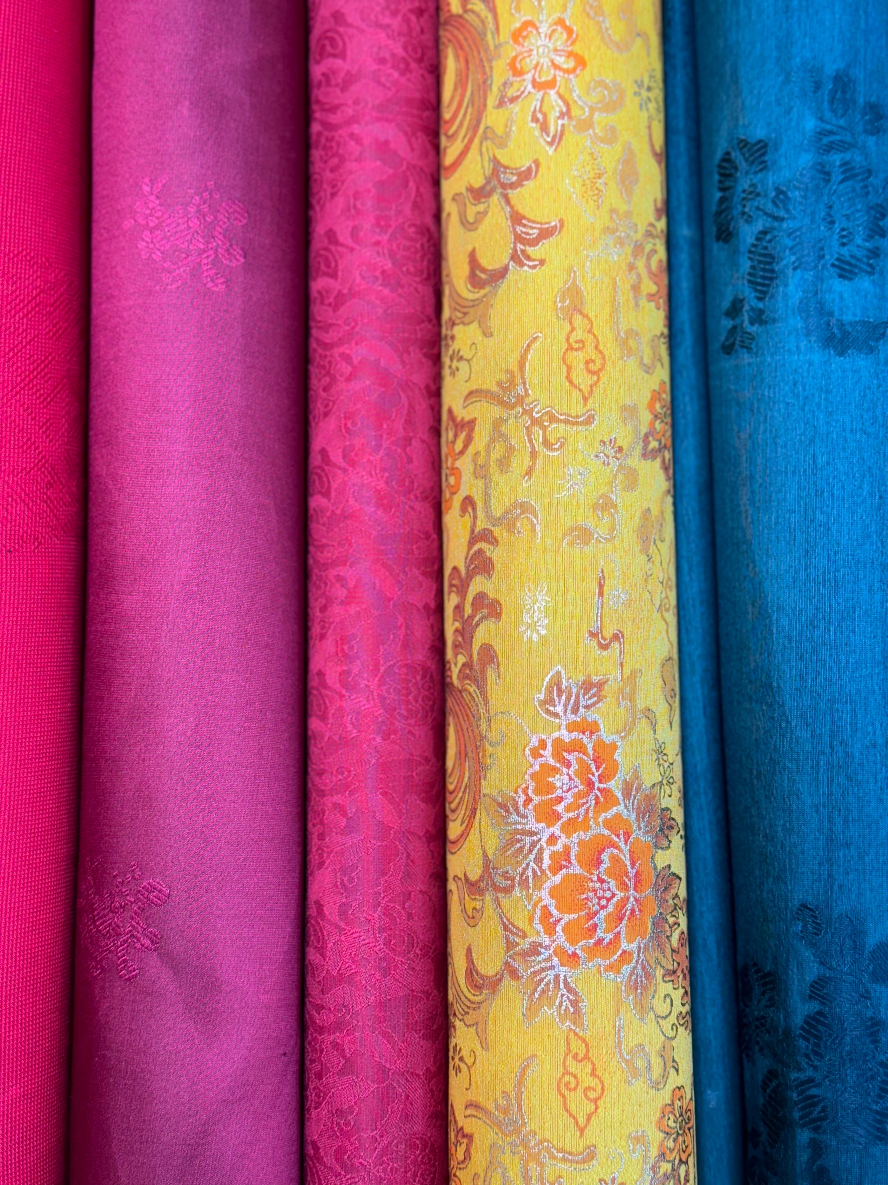 Stack of Decorative Textured Fabric Rolls · Free Stock Photo