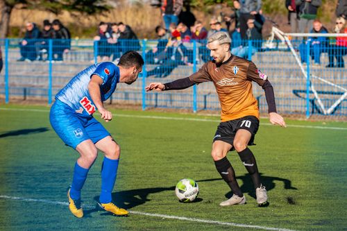 Free Two male soccer players in action during a competitive match on a grass field. Stock Photo