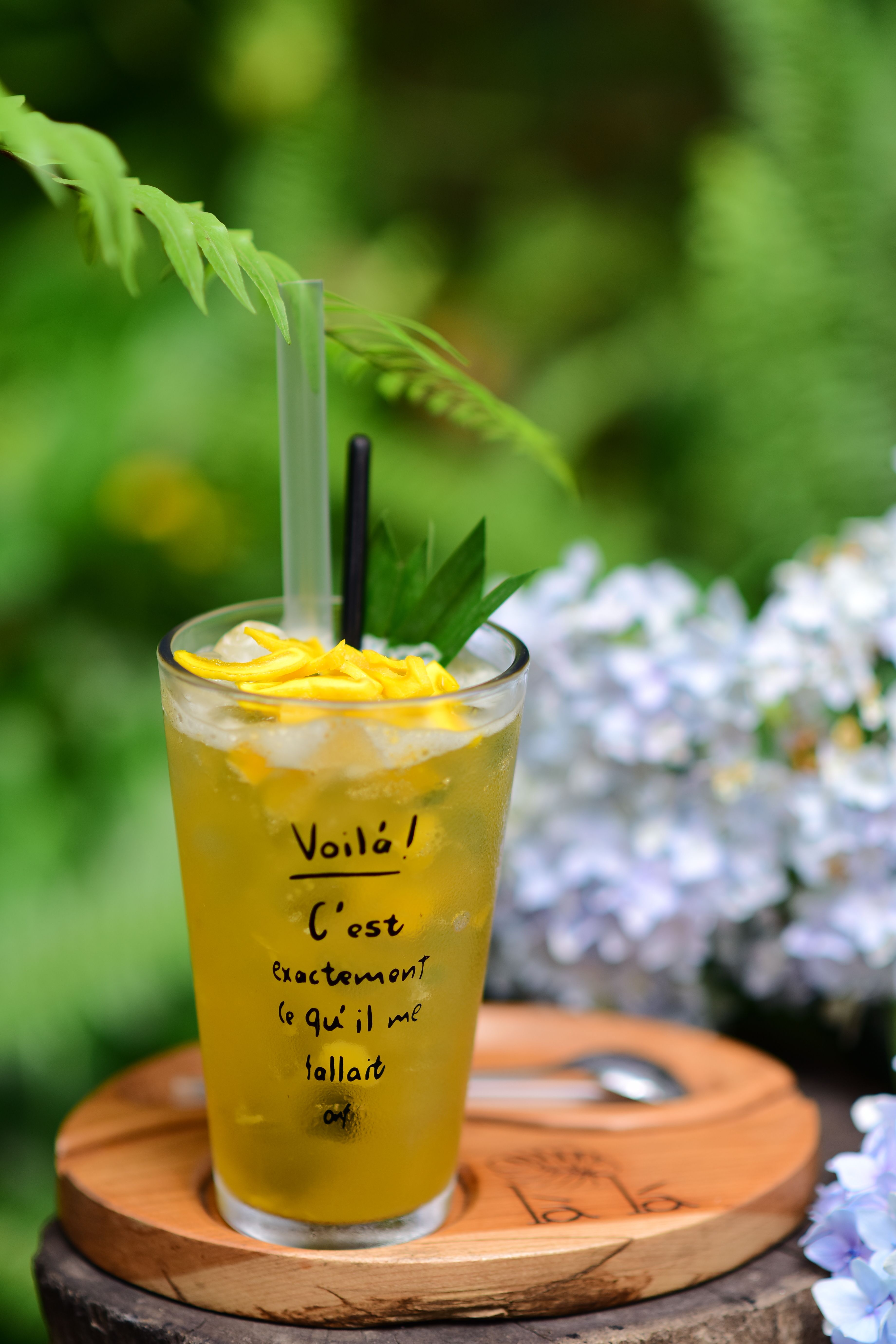 Lemon iced drink with fresh greenery and flowers, perfect for summer.