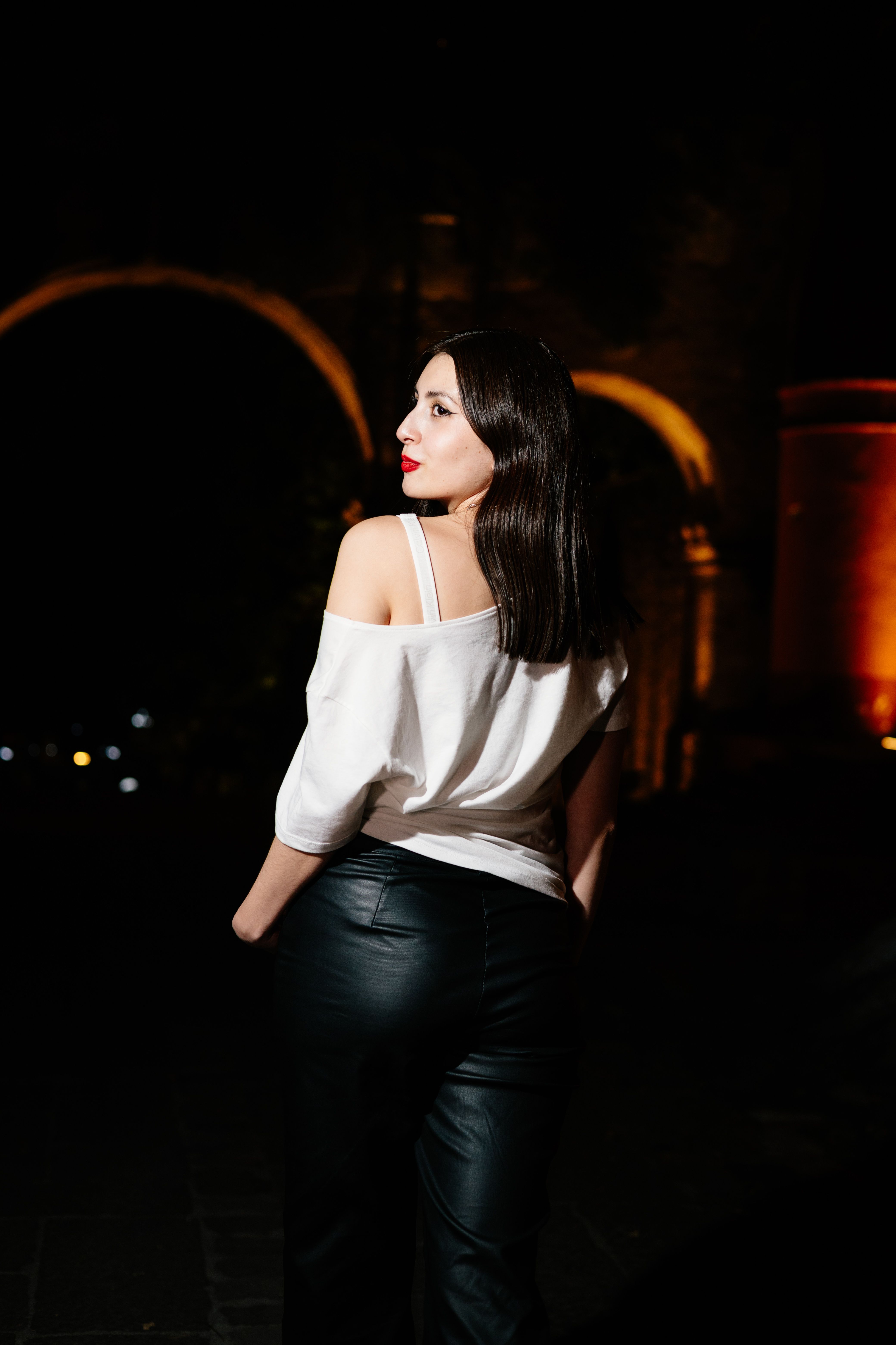 Woman in Stylish Attire Posing at Night · Free Stock Photo