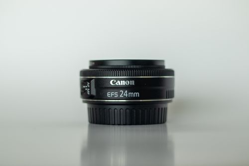 Free Close-up of a Canon EFS 24mm camera lens with reflection, perfect for photography enthusiasts. Stock Photo