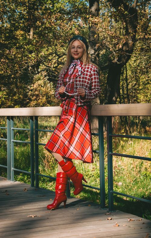 Free Stylish woman in red plaid clothing standing on a wooden bridge outdoors in autumn. Stock Photo