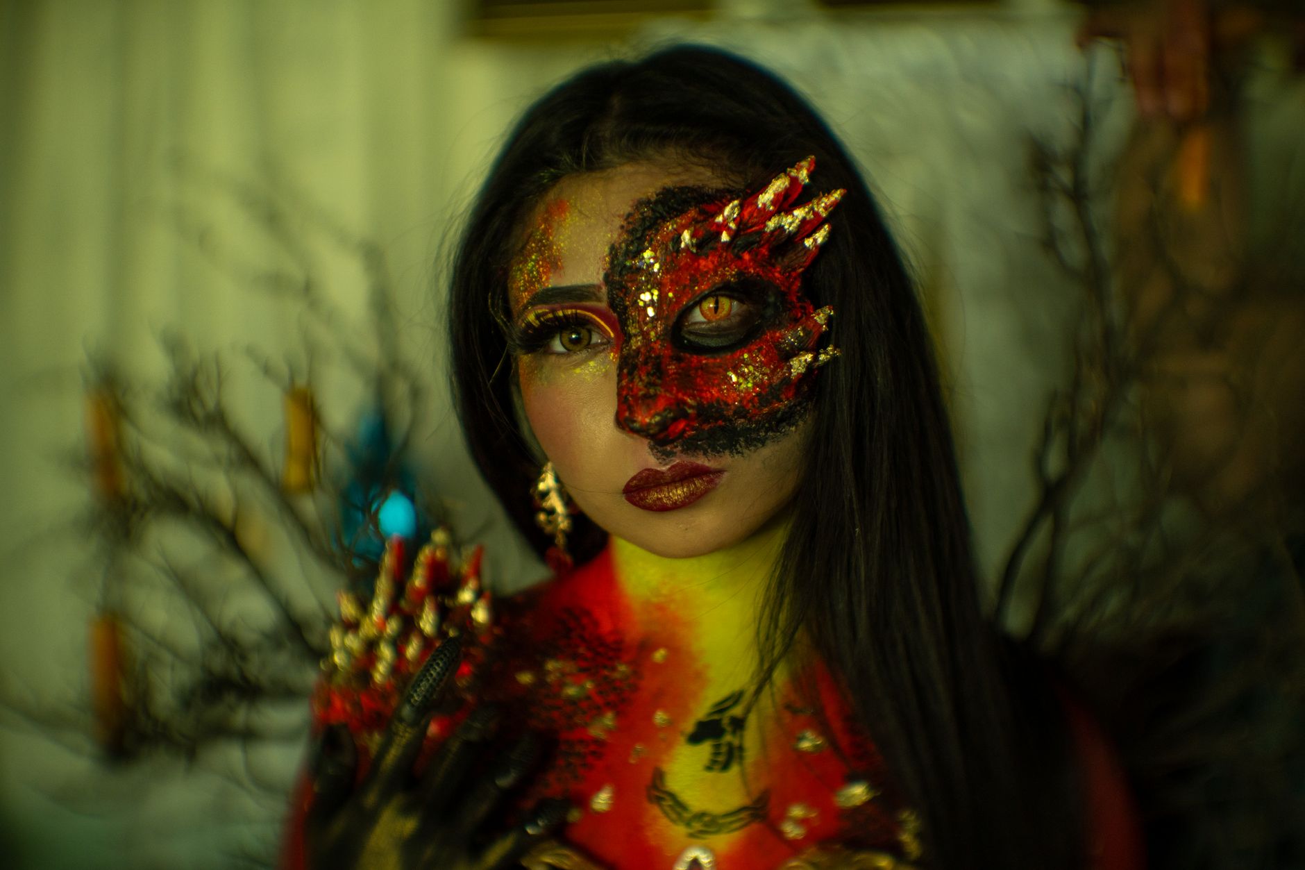 Portrait of a woman with dragon-themed makeup and costume, exuding vibrant colors and creative Halloween vibes.