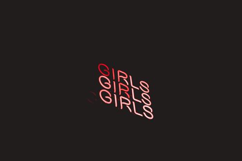 Free Vibrant neon sign displaying the word 'Girls' in red against a dark background. Stock Photo