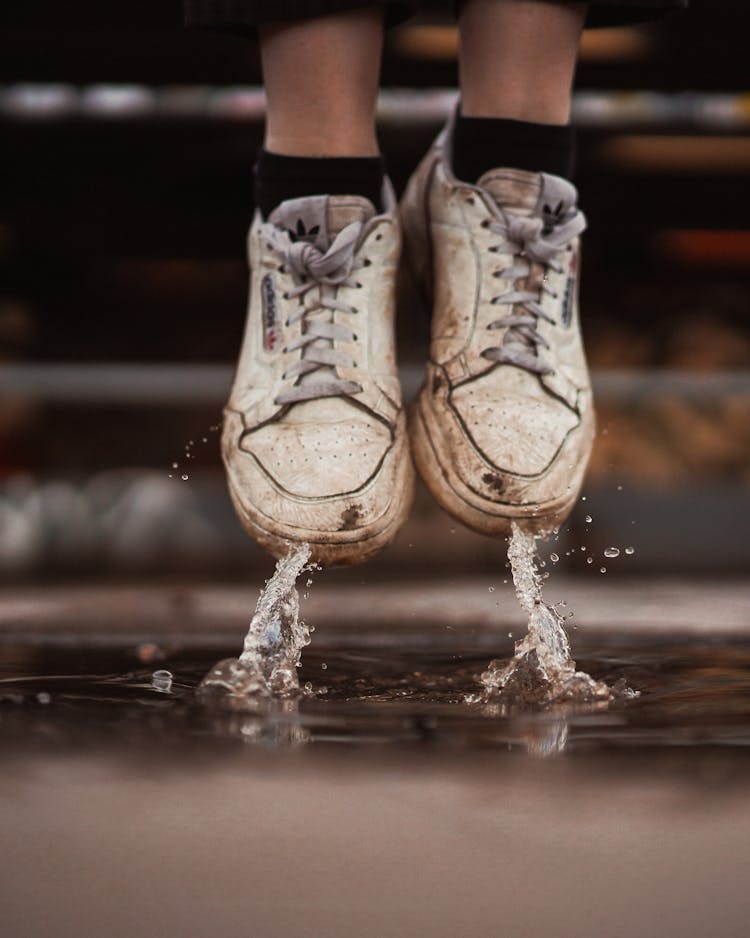 Close-Up Photo Of Person Wearing Adidas Shoe