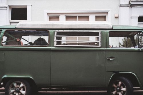 Free Vintage green Volkswagen van parked on a London street, showcasing classic retro design. Stock Photo