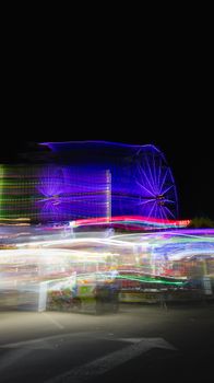 Long exposure shot capturing a colorful Ferris wheel at a nighttime carnival with vibrant lights.. pexels, long, exposure