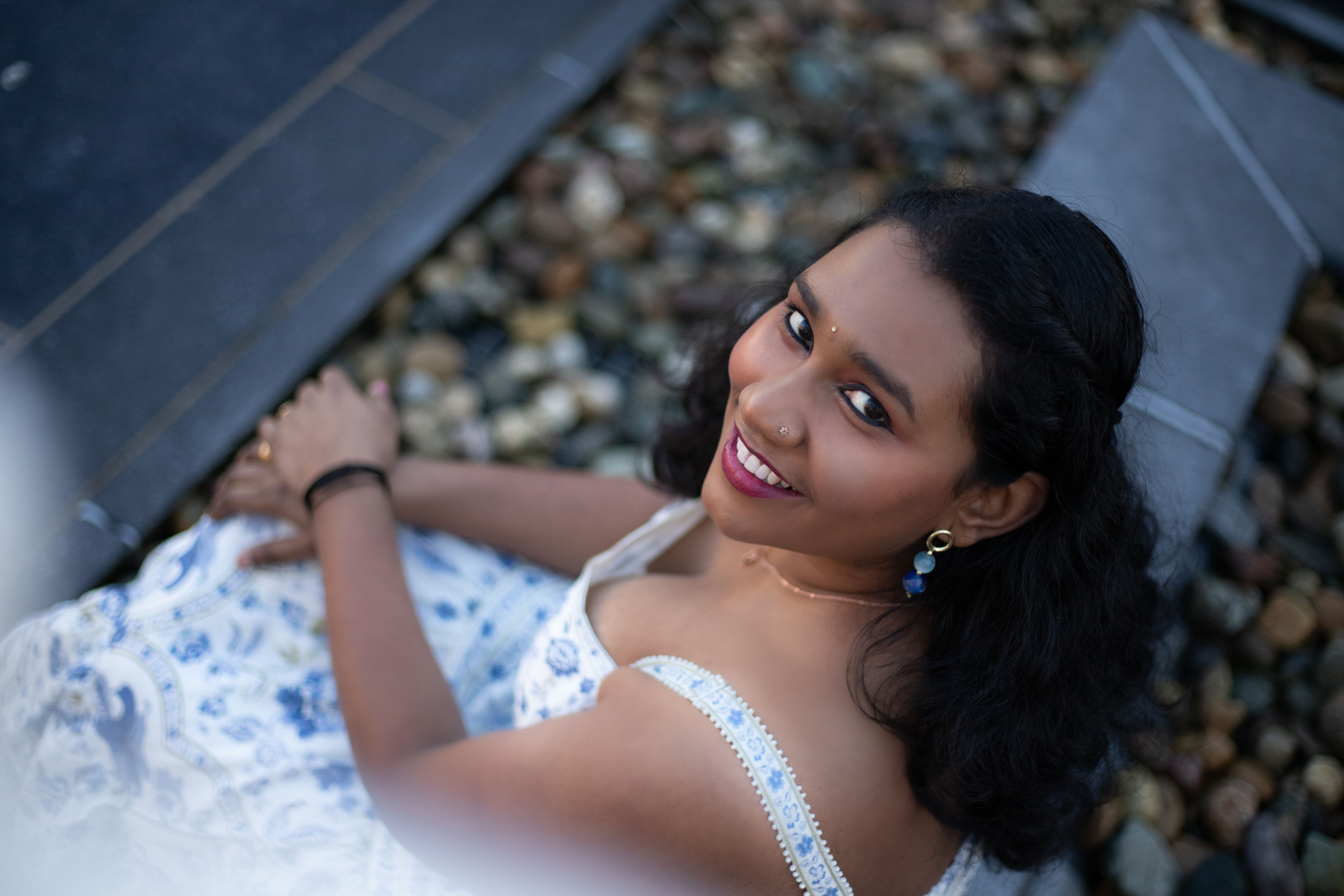 Smiling Woman in Blue Patterned Dress Outdoors