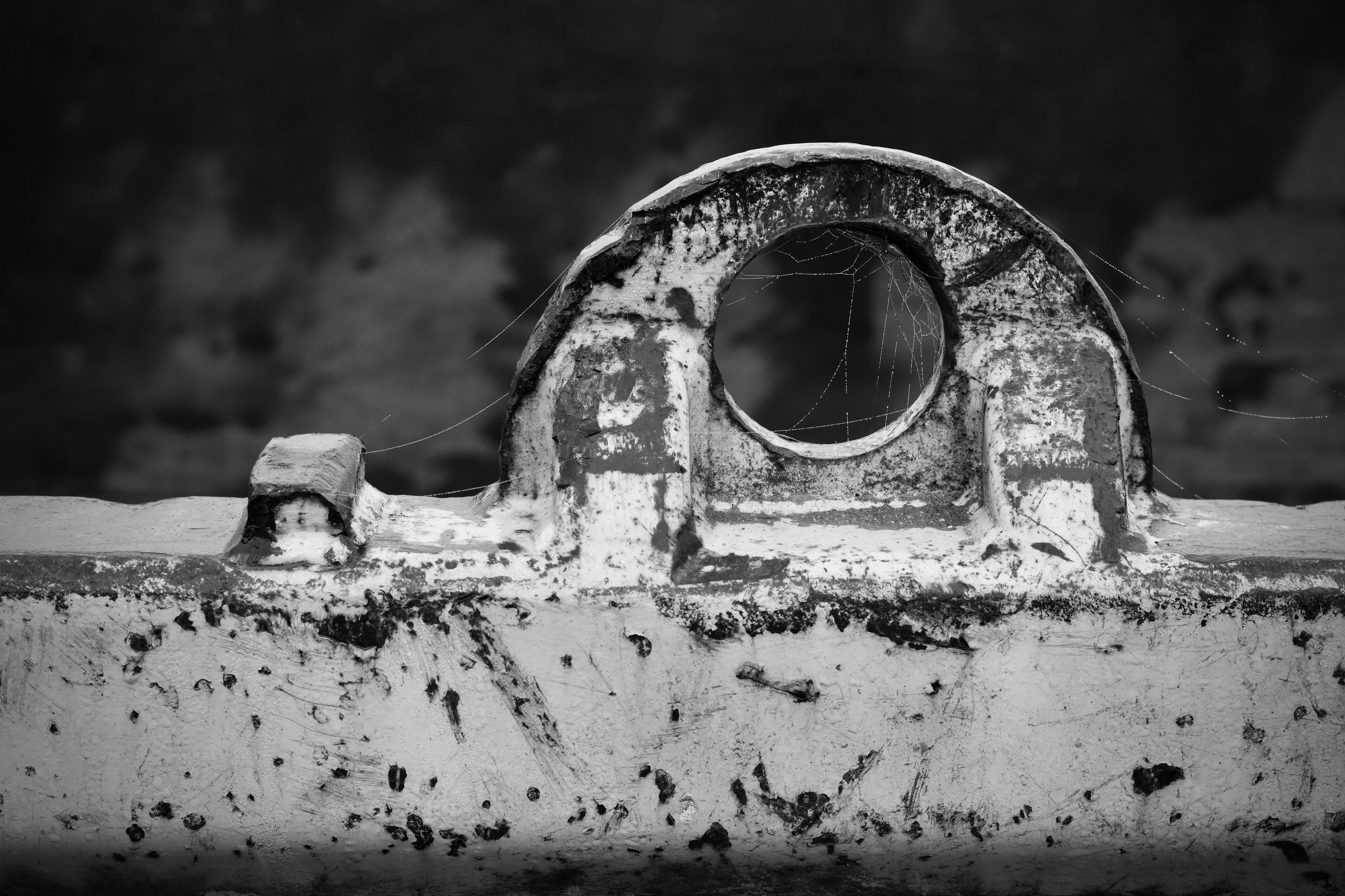 Free A black and white abstract image of a rusty metal structure with spider webs. Stock Photo
