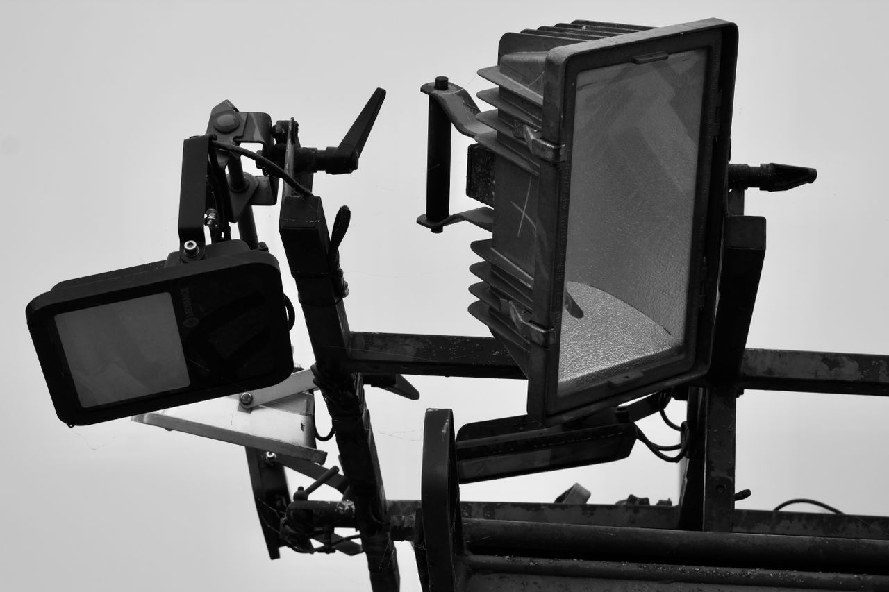 Black and white closeup of studio lighting equipment highlighting modern design and industrial look.
