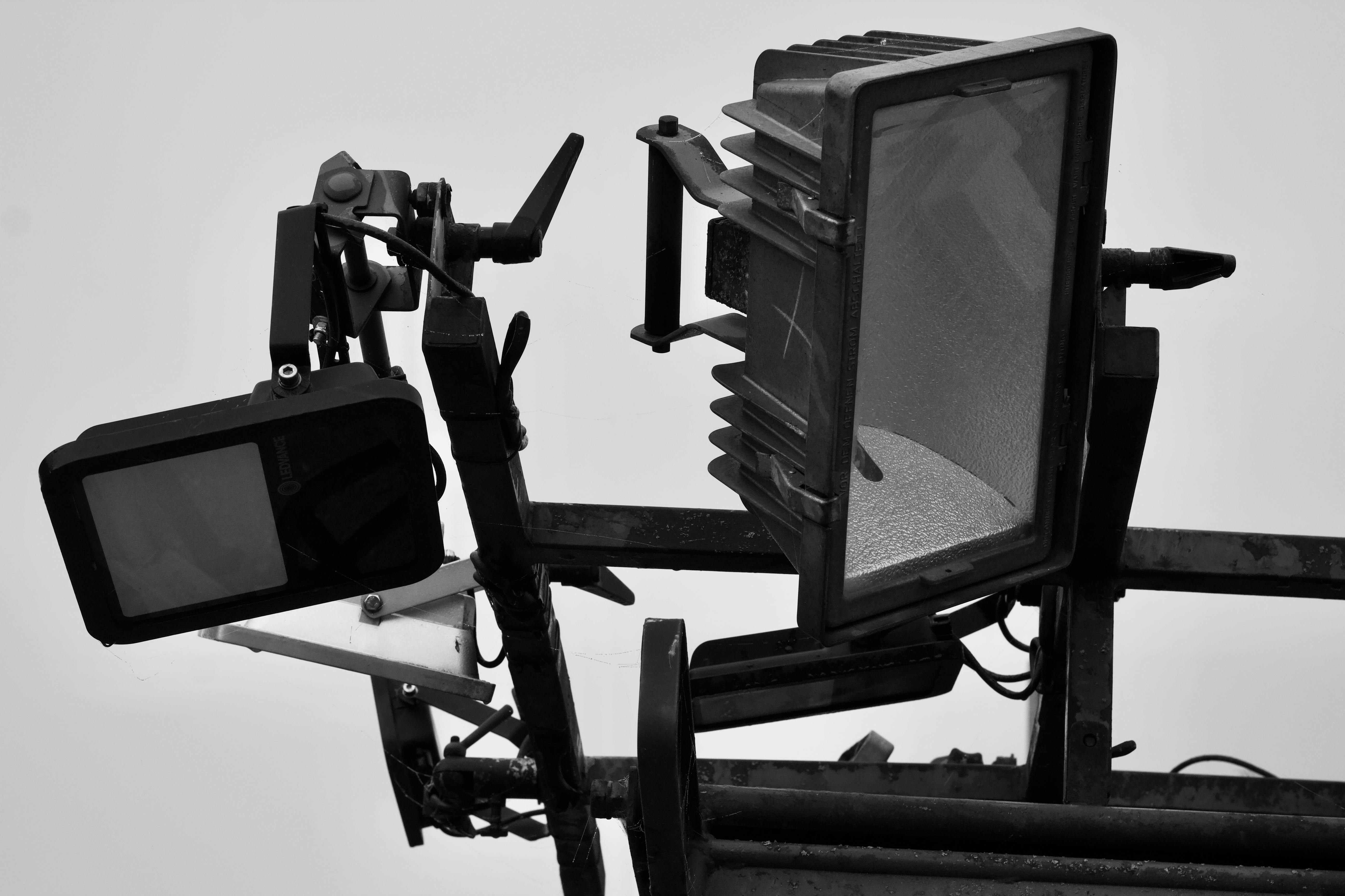 Free Black and white closeup of studio lighting equipment highlighting modern design and industrial look. Stock Photo