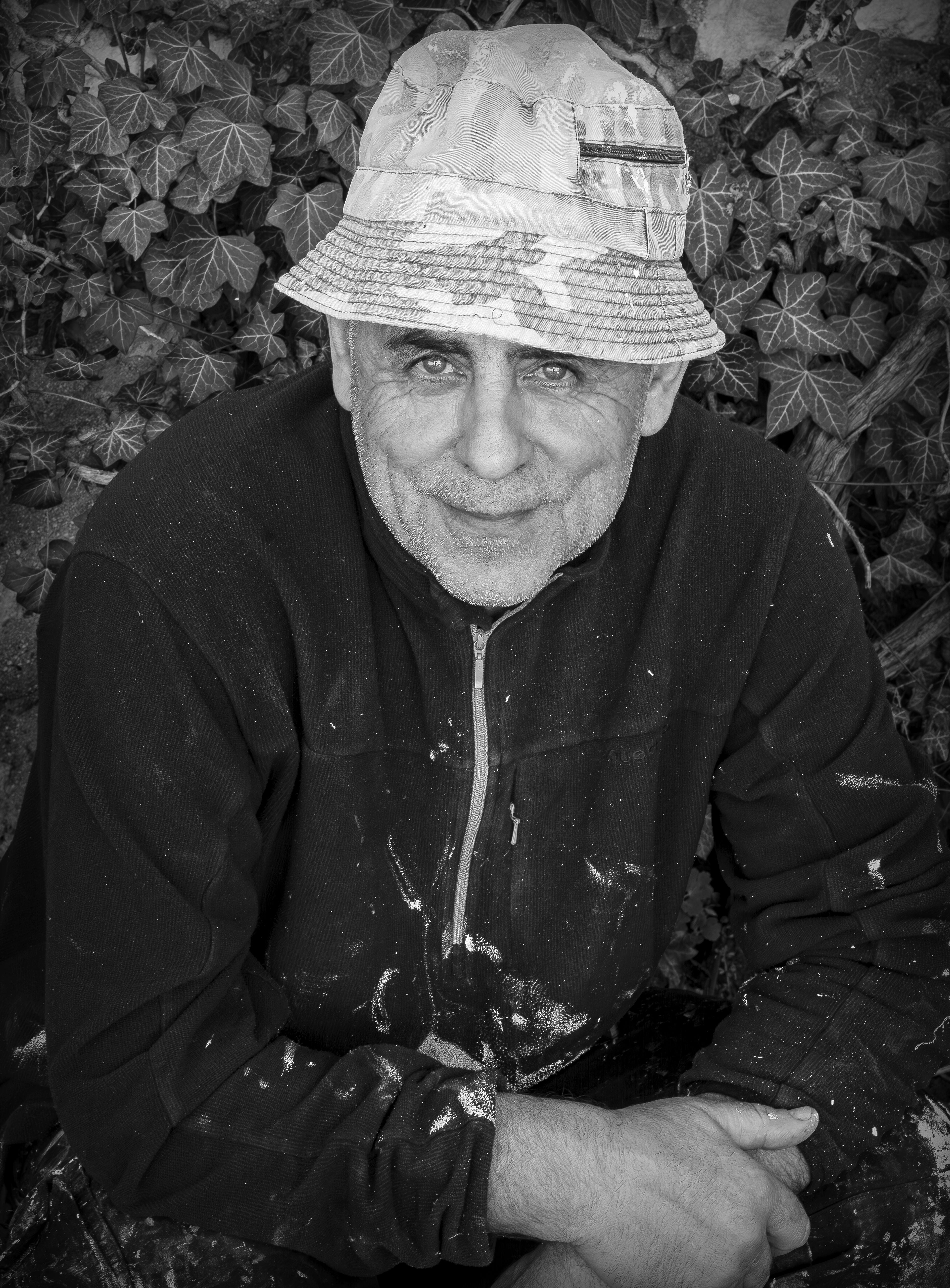 Gratis Ritratto artistico in bianco e nero di un uomo maturo con un cappello, circondato da foglie d'edera. Foto a disposizione