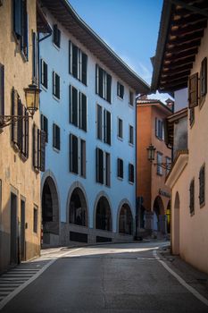 A picturesque scene of colorful architecture on a street in San Daniele del Friuli, Italy.