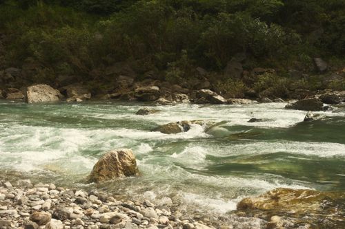 Free Tranquil river scene with boulders and lush greenery in Tanay, Philippines, ideal for nature and travel inspiration. Stock Photo
