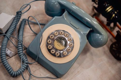 Free Classic blue rotary dial telephone showcasing nostalgic technology, ideal for vintage-themed designs. Stock Photo