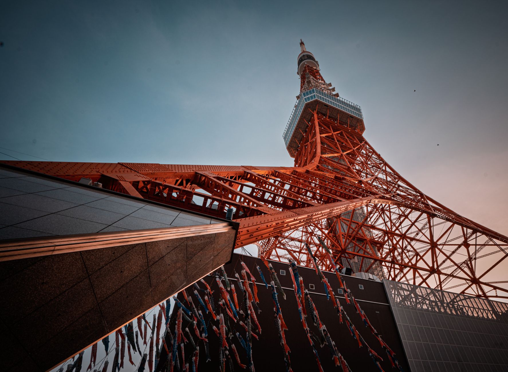 A low-angle view of Tokyo Tower in Minato City, Tokyo, Japan during sunset.