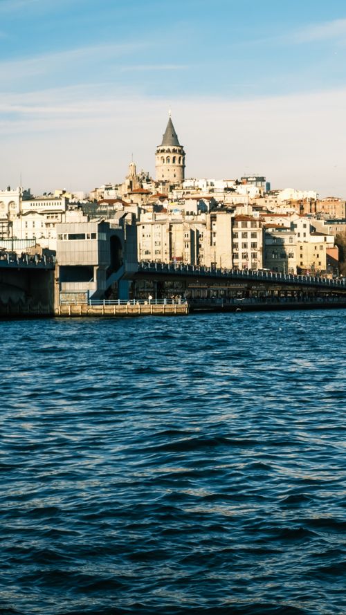 Free View of the iconic Galata Tower and Bosphorus Bridge across the water, Istanbul. Stock Photo
