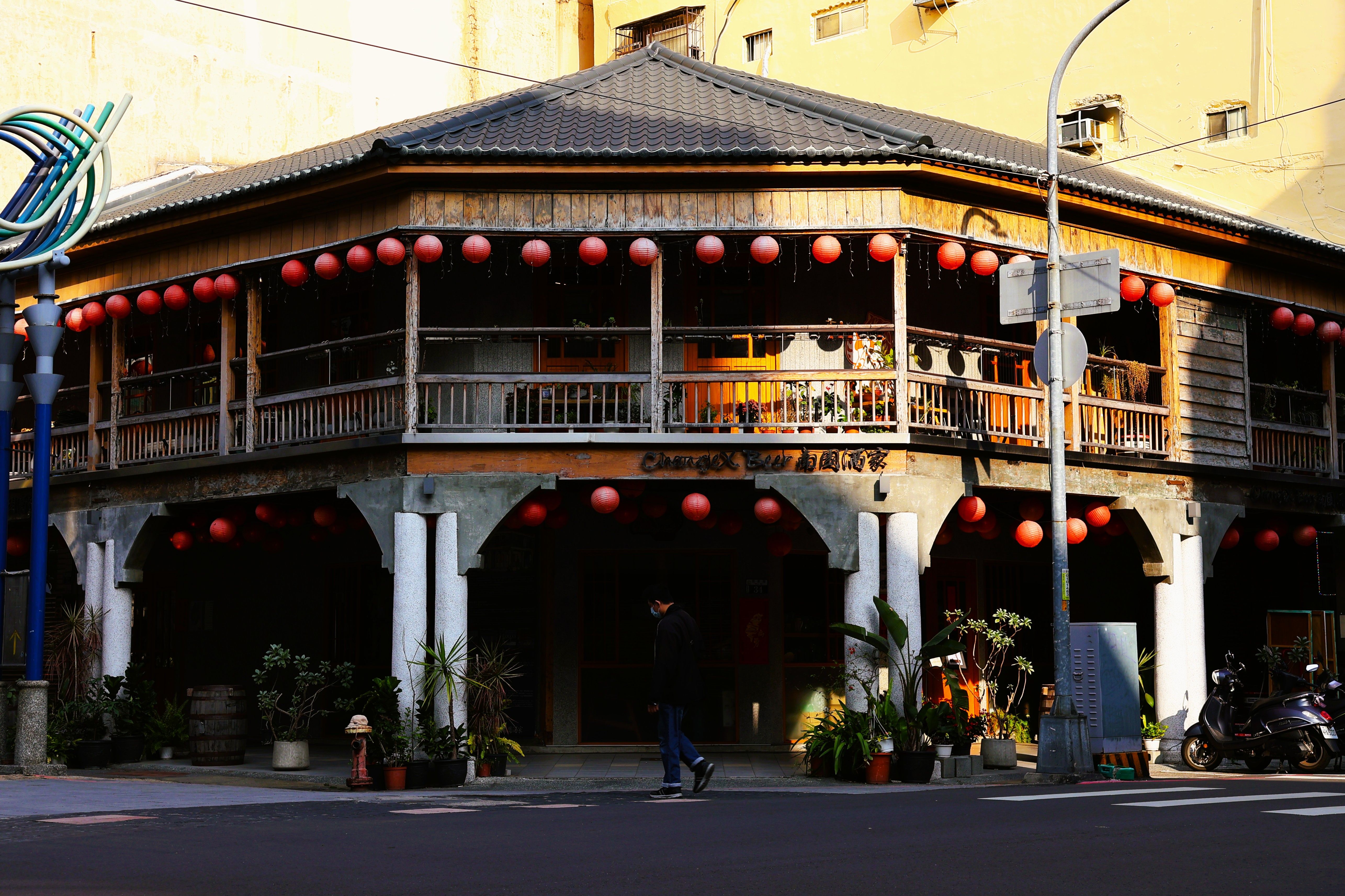 Charming street view of a traditional Taiwanese building adorned with red lanterns, capturing Taiwan's cultural essence.