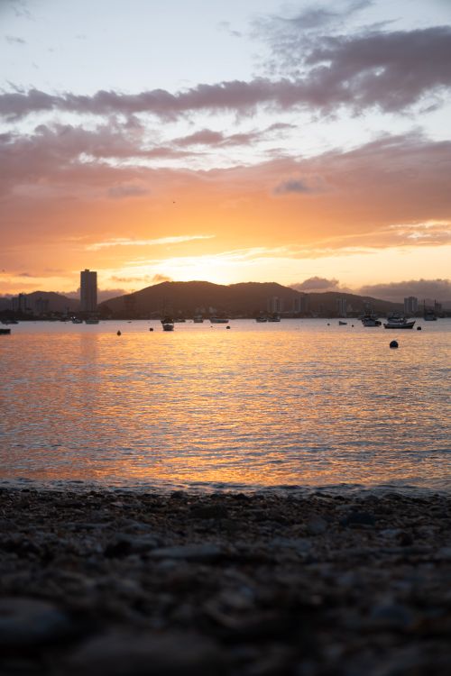 Free Beautiful sunset view over the coast of Santa Catarina, Brazil with reflections on the ocean. Stock Photo
