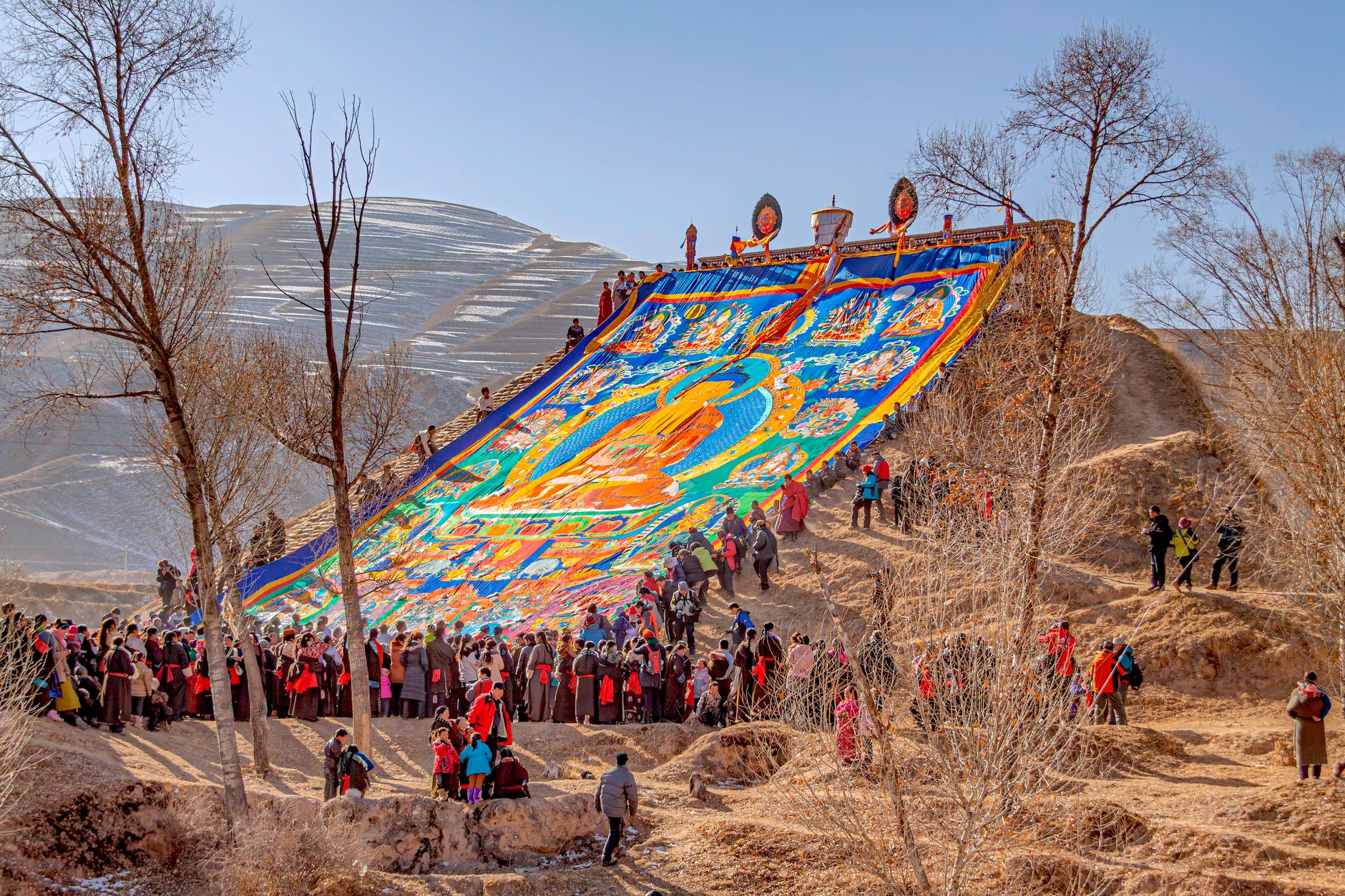 Captivating display of Tibetan culture during a vibrant outdoor festival in Qinghai, China.