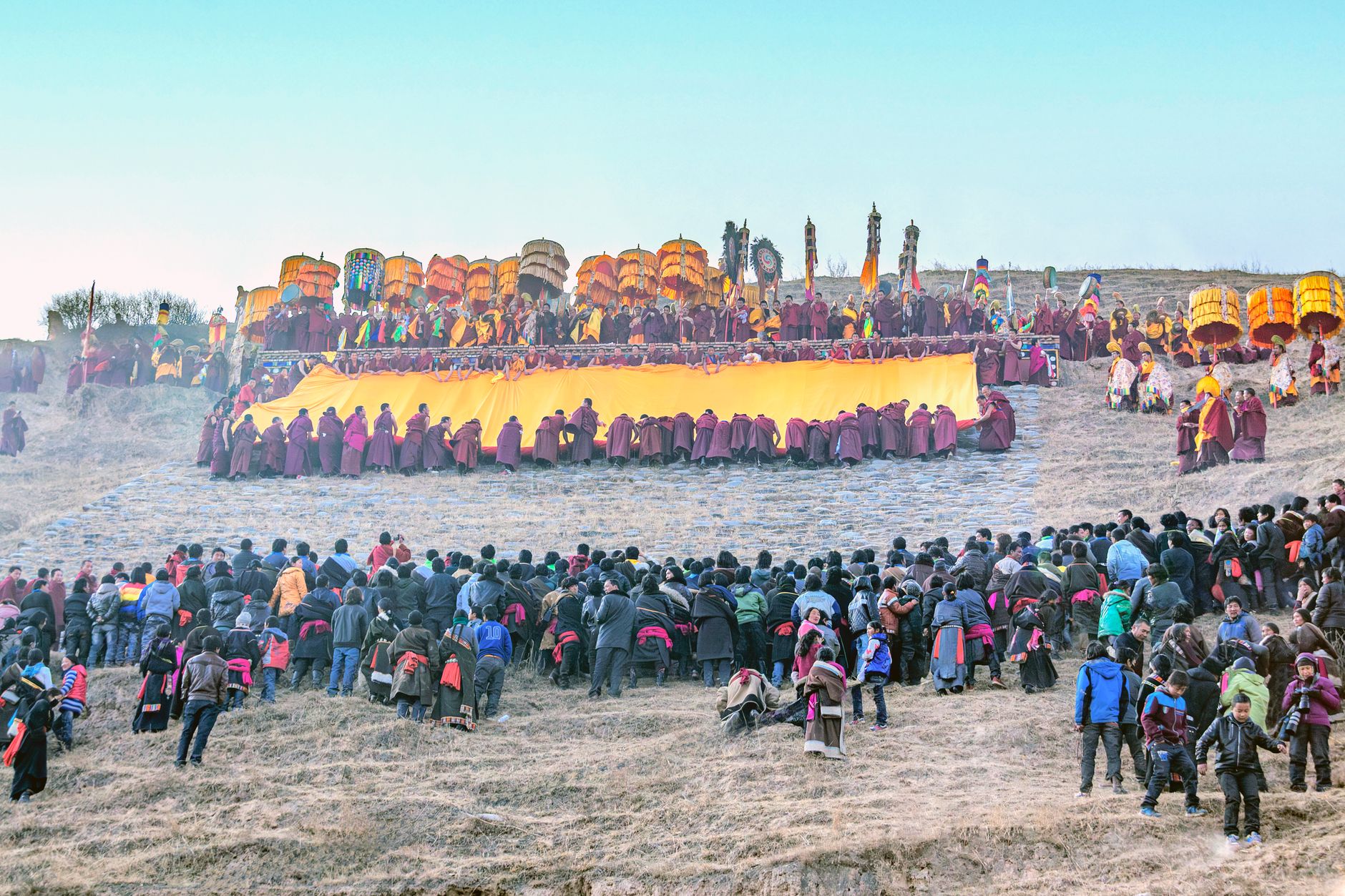 Tibetan monks and villagers gather for a spiritual ceremony in Qinghai, China.
