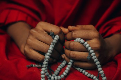 Free A serene close-up of hands holding prayer beads, symbolizing meditation and spirituality. Stock Photo