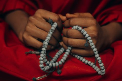 Free Close-up of hands holding prayer beads, symbolizing faith and spirituality. Stock Photo