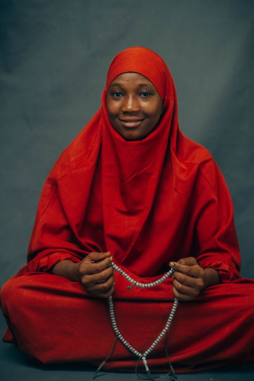 Portrait of a Woman in Red Hijab with Prayer Beads · Free Stock Photo