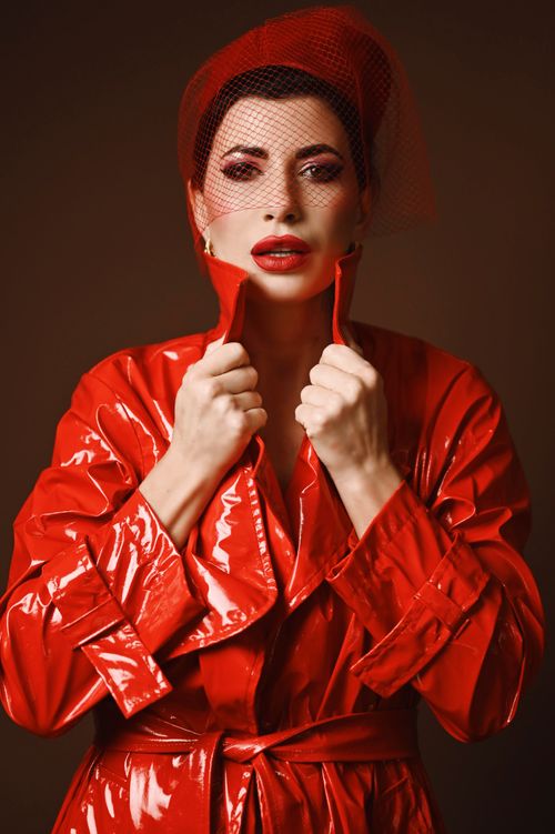Free Striking portrait of woman in vibrant red, highlighting modern fashion trends with a dramatic flair. Stock Photo