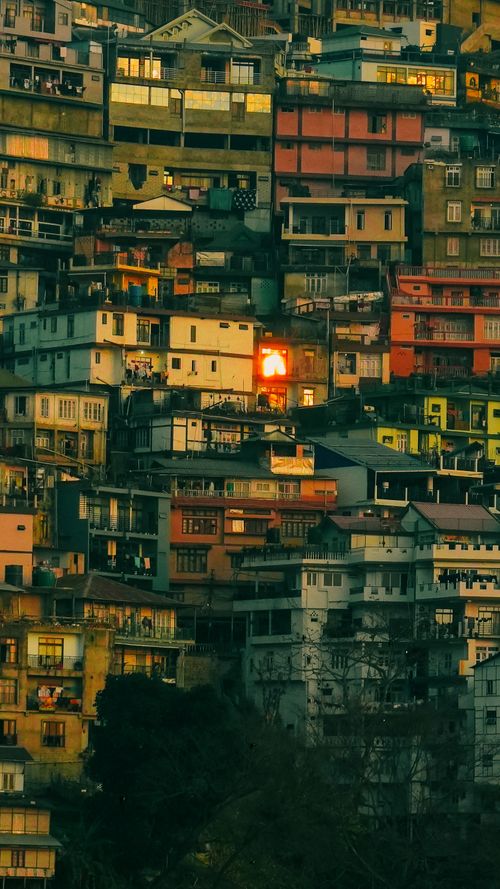Free Colorful stacked houses on a hillside at twilight creating a vibrant cityscape. Stock Photo