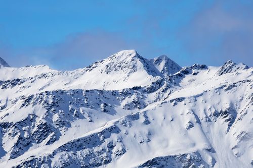 Free Majestic snow-capped mountains under a clear blue sky, Korutany, Austria. Stock Photo