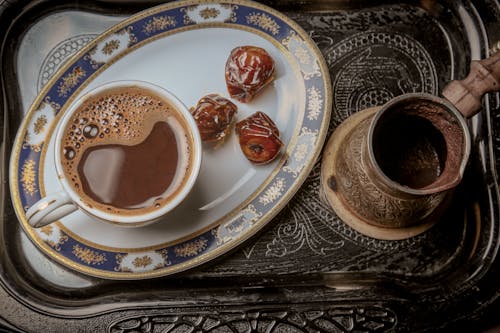 Free Cup Of Coffee With Dates On A Serving Tray Stock Photo