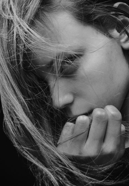 A striking black and white portrait of a young woman in Kyiv, conveying deep thought and emotion.