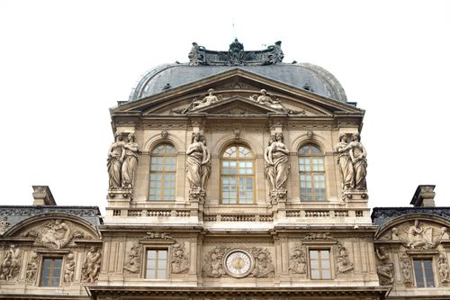 Free Close-up of the ornate architectural details on the Louvre Museum facade in Paris, France. Stock Photo