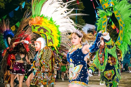 Free Colorful costumed dancers performing in a traditional festival under the night sky. Stock Photo