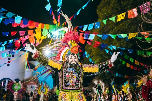 Free Colorful Mexican festival with traditional costumes, dancing, and festive decorations at night. Stock Photo