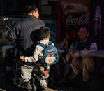 Street Scene with Child on Motorbike in Urban Setting