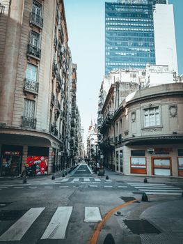 Quiet street scene in Buenos Aires, showing historic architecture and modern skyscrapers.