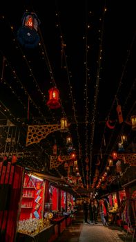 A vibrant night market with colorful lanterns and festive decorations creating a lively atmosphere.