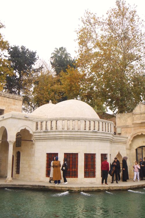 Free Historic domed structure surrounded by tourists in park setting, fall season. Stock Photo
